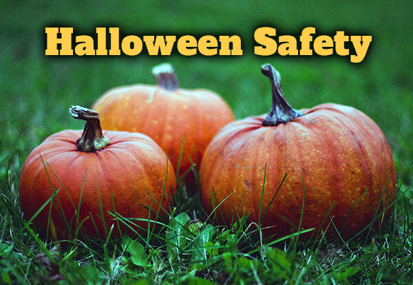 Three pumpkins on the ground with text that reads Halloween Safety