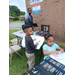 A little boy and girl coloring in their posters.