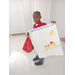 A little boy posing with his poster in front of him.