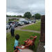 A child watching a man walk by while eating ice-cream.