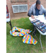 A man working on a poster with an open case of markers in front of him.