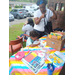 A child working on his poster while surrounded by What Home Means to Me contest flyers.