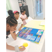 Three children working hard on their posters.