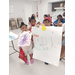 Three children showing off their posters for the camera.