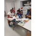 Individuals working on their posters and smiling at the camera.