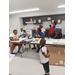 A little boy watching others work on their posters.