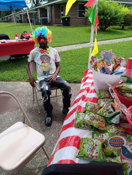 A clown at the snack table.