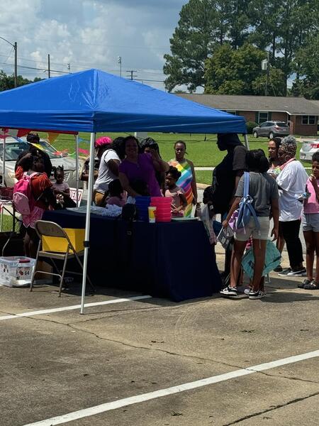 A gathering of people getting school supplies.