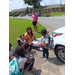 A group of people sitting outside visiting.