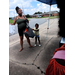 A lady and a little girl holding a bag.