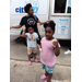 A woman and two kids eating ice cream treats.