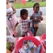 Children standing by a table full of snacks.