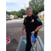 Officer carrying bags for the event.