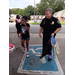 Officer holding bags next to residents.