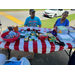 People seated behind the school supply table.