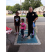 Smiling officer holding bags next to residents.