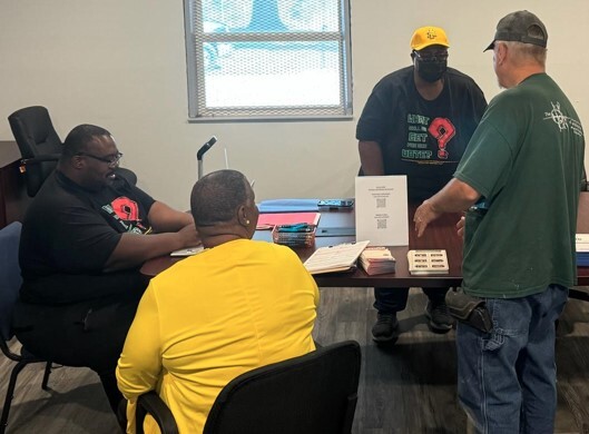 A group of men sitting around a table.