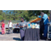 A person standing next to a table with food and drinks.