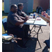 Two people sitting behind a table.