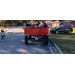 A group of children in a a large red wagon.