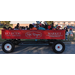 A group of people in a large red wagon.