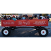 A group of people sitting in a large wagon.