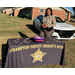 An officer standing behind the Northhampton County Sheriff's Office table with candy on it.