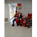 A young lady and a boy with Santa.