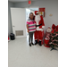 Santa standing with a lady at the cookie and cocoa event.