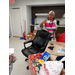 Lady holding a cup surrounded by items for the food giveaway.